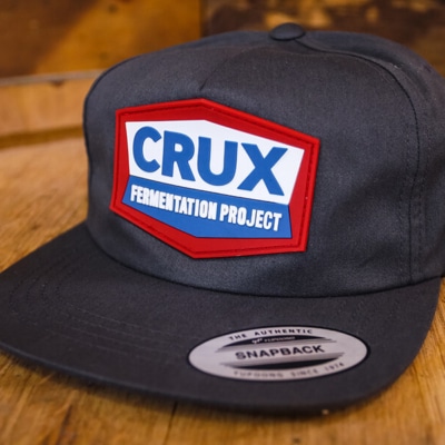 Crux Fermentation Project flatbill charcoal hat with aamco inspired logo