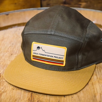 Crux Fermentation Project mountain stripe patch on a 5-panel camper hat